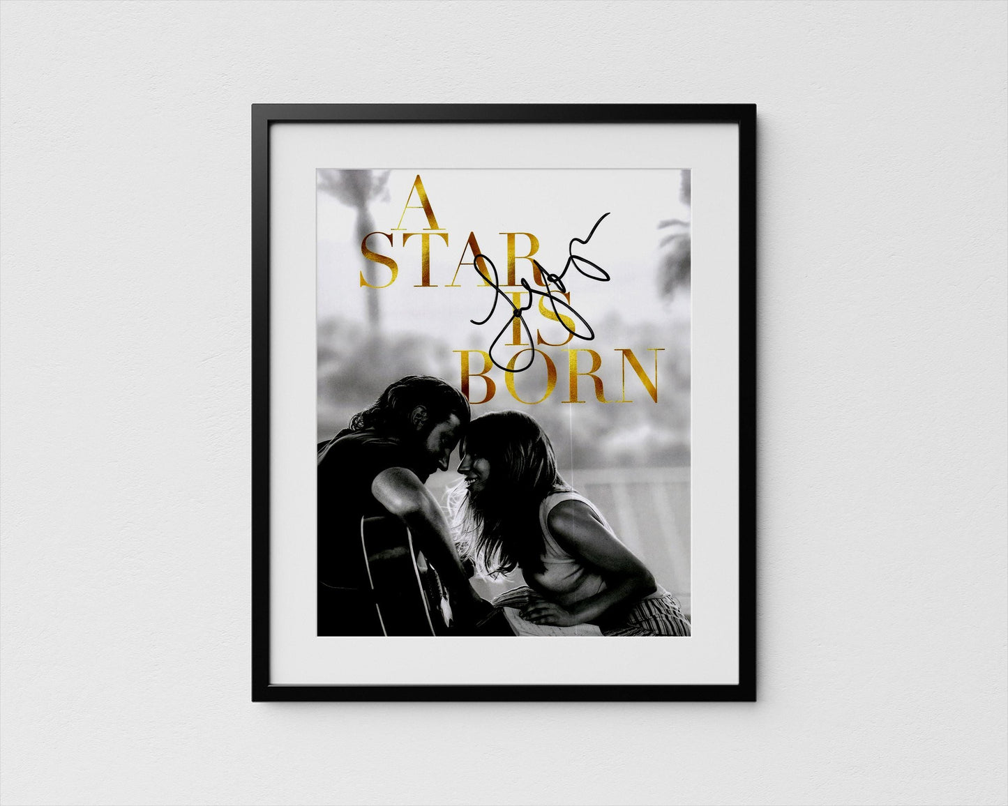 A framed black and white photograph of a couple embracing, with the text "A STAR IS BORN" written above them.