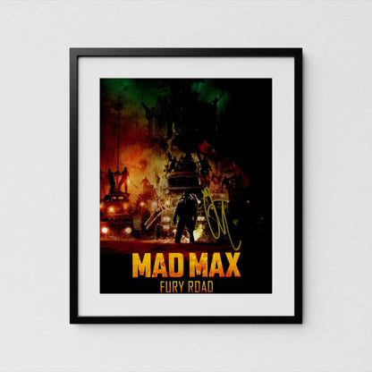 The image is a framed poster or artwork featuring a scene from the movie &quot;Mad Max: Fury Road&quot;. The poster has a dark, dramatic background with various vehicles and people, creating a sense of chaos and tension. The title &quot;Mad Max: Fury Road&quot; is prominently displayed in large, bold letters at the bottom of the poster.