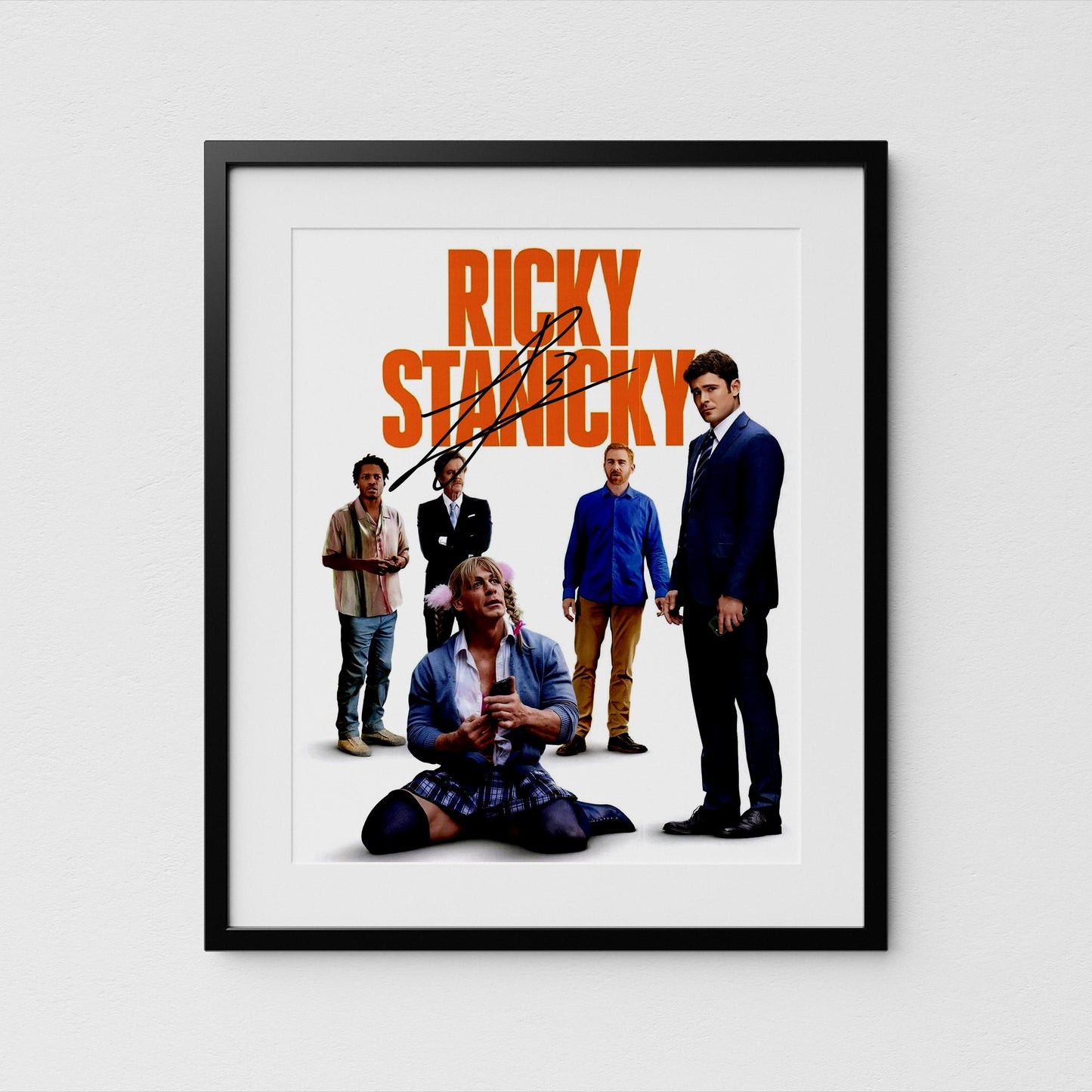 The image is a framed poster featuring the title character, Zac Efron, along with several other characters from the film.