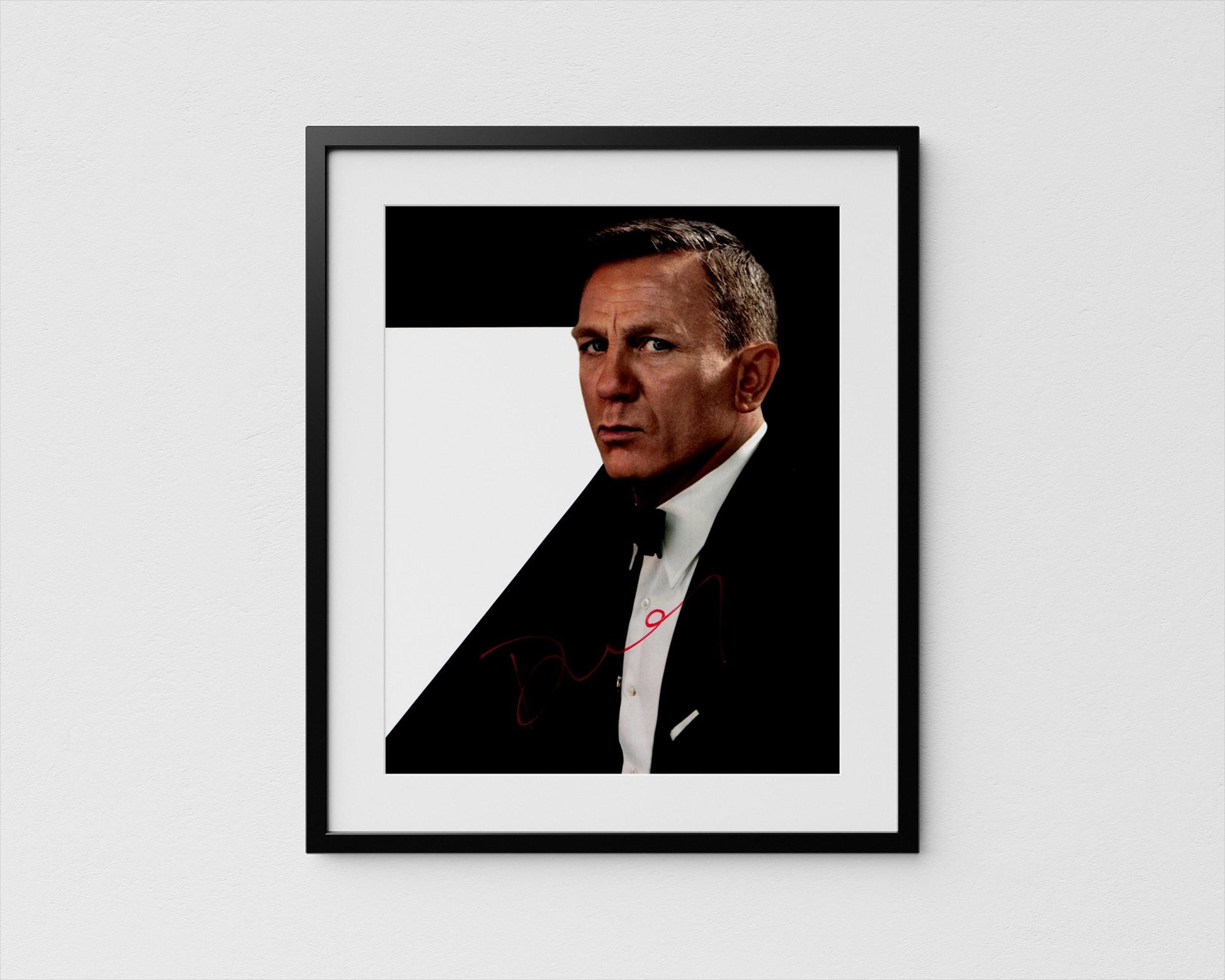 A framed portrait of a man in a suit, with a serious expression on his face.