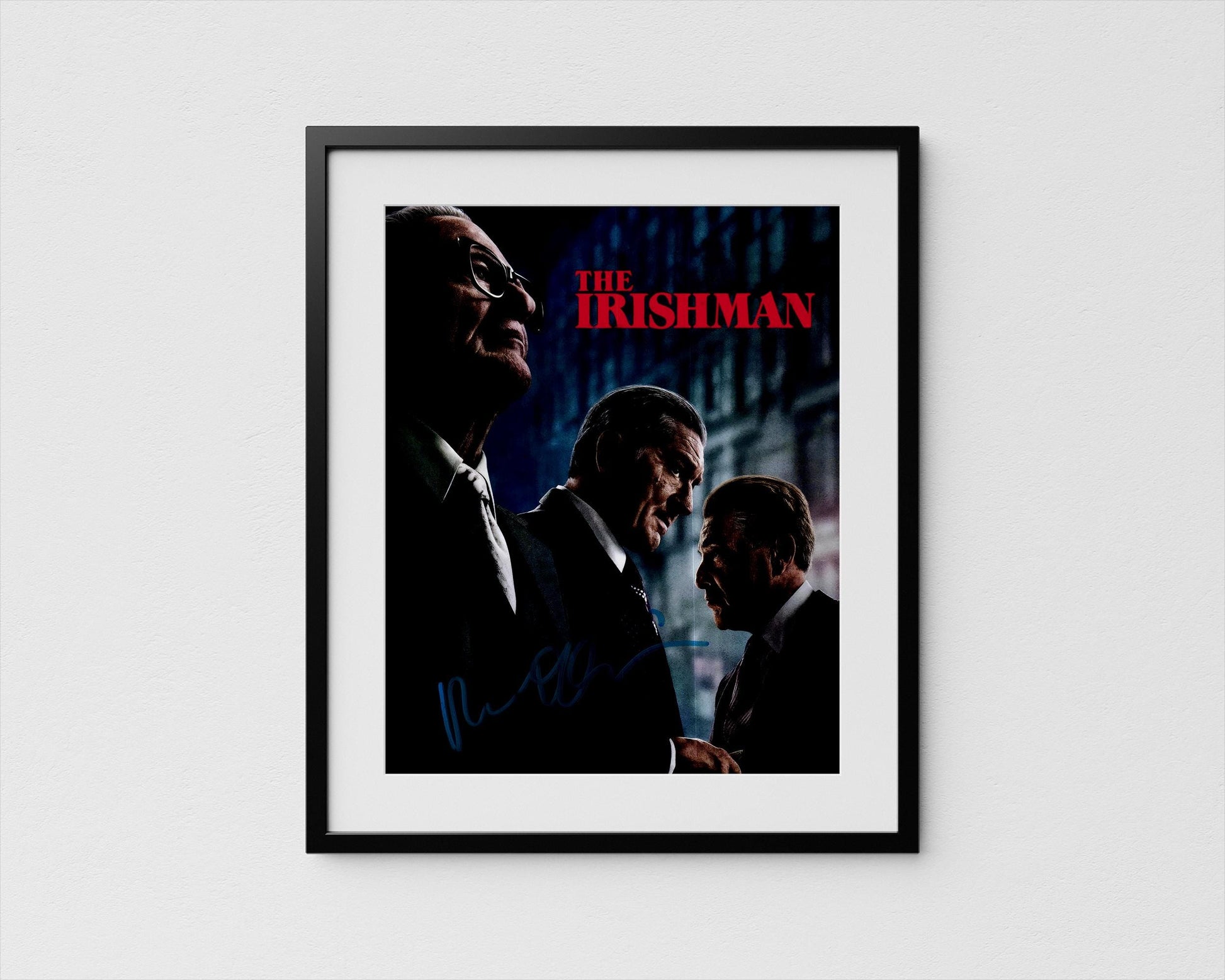 The image is a framed poster featuring three men in suits, with the title &quot;The Irishman&quot; prominently displayed.