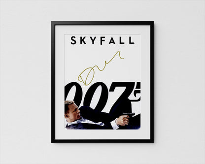 A framed poster featuring a man in a suit holding a gun, with the text &quot;SKYFALL 007&quot; prominently displayed.