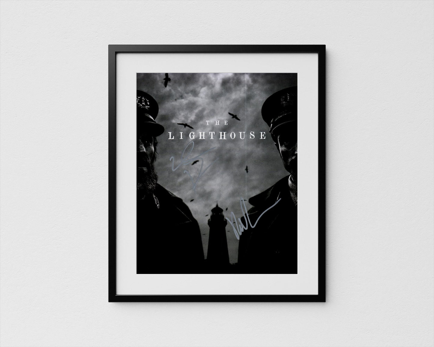 The image is a framed poster featuring two silhouetted figures, likely representing characters from a film or television show, with a lighthouse in the background.