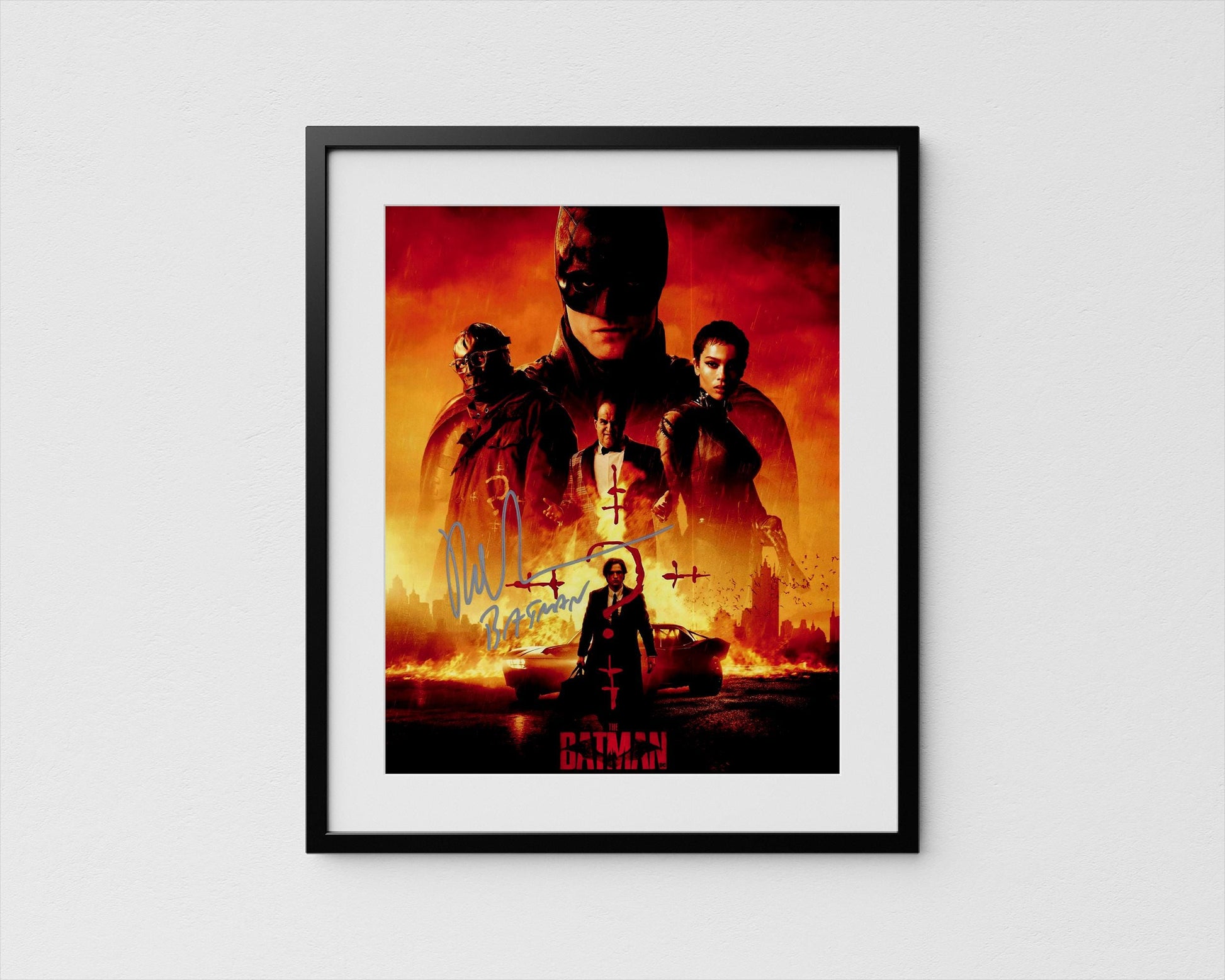 The image is a framed poster featuring the Batman logo and various characters from the Batman franchise, including the iconic superhero himself.