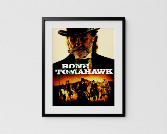 The image is a framed poster featuring a close-up of a man&#39;s face wearing a hat, with a cowboy hat and a bandana. The poster also includes a collage of other images depicting people on horseback, suggesting a western or cowboy theme.
