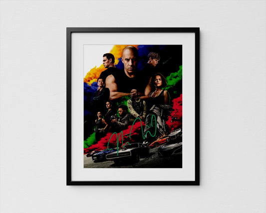 The image is a framed poster featuring a collage of various characters from a movie, including a bald man, a woman, and other individuals.