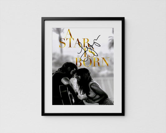 A framed black and white photograph of a couple embracing, with the text &quot;A STAR IS BORN&quot; written above them.