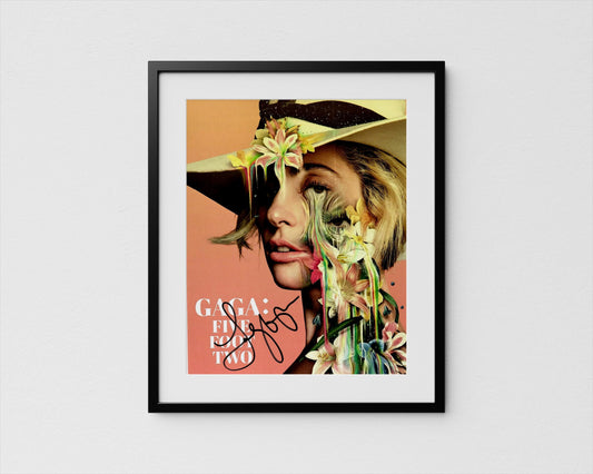 The image is a framed poster featuring a close-up portrait of a woman with a flower-adorned hat.