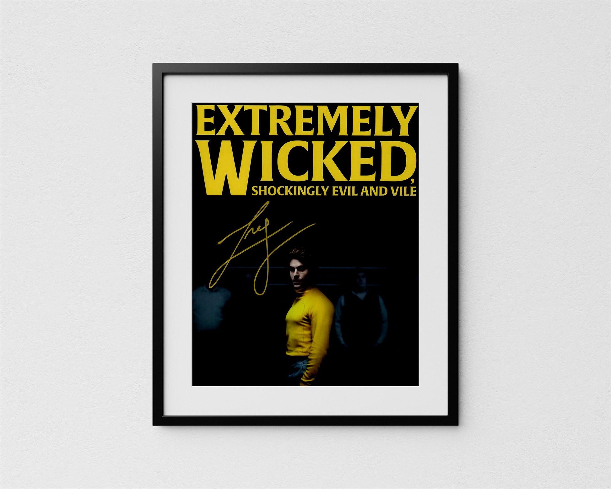 The image is a framed poster with a person in a yellow shirt and a dark background. Zac Efron