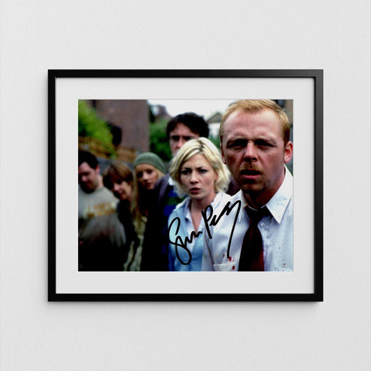 The image is a framed photograph of a group of people, with a man in a suit and tie prominently featured in the foreground.