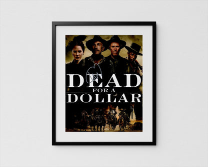 The image is a framed poster featuring the title &quot;Dead for a Dollar&quot; along with a group of people in cowboy hats and clothing, likely representing characters from a western film.