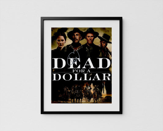 The image is a framed poster featuring the title &quot;Dead for a Dollar&quot; along with a group of people in cowboy hats and clothing, likely representing characters from a western film.