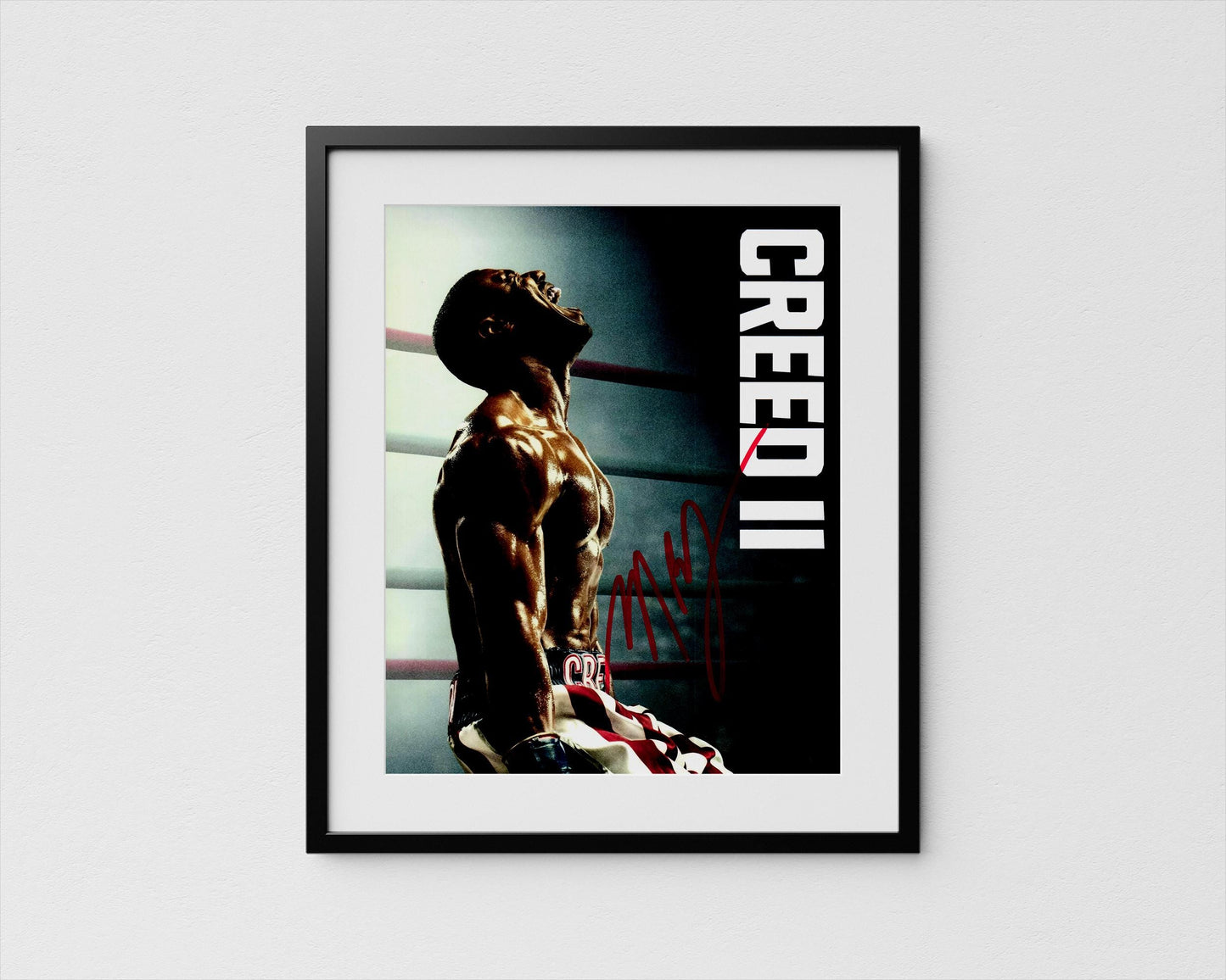 The image is a framed poster featuring a muscular man in a boxing ring, with the word &quot;CREED&quot; prominently displayed.