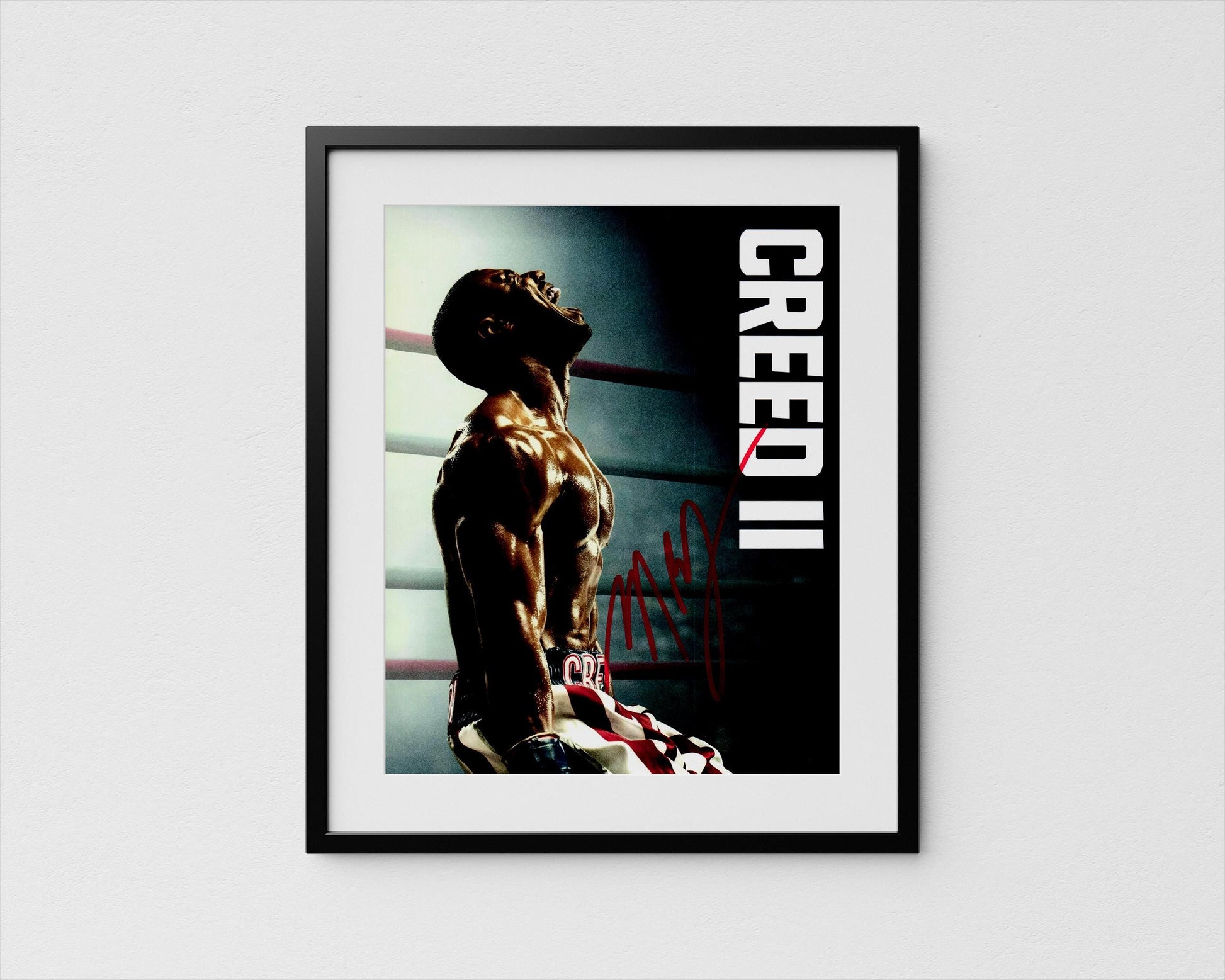 The image is a framed poster featuring a muscular man in a boxing ring, with the word &quot;CREED&quot; prominently displayed.