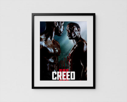 The image is a framed poster featuring two muscular men facing each other, with the word &quot;CREED&quot; prominently displayed in the center.