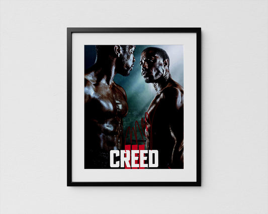 The image is a framed poster featuring two muscular men facing each other, with the word &quot;CREED&quot; prominently displayed in the center.