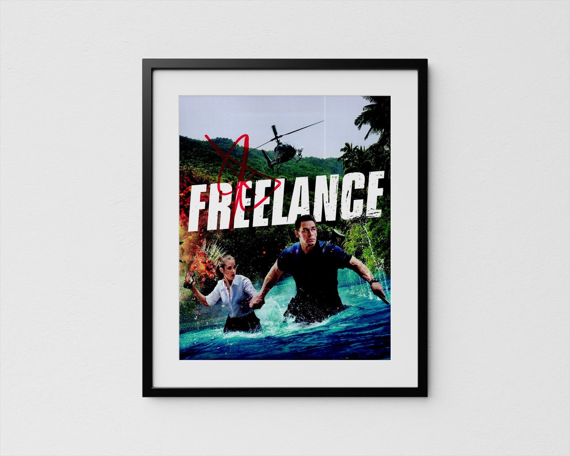 The image is a framed poster featuring a man and a woman in a tropical setting, with a helicopter in the background. The word &quot;FREELANCE&quot; is prominently displayed in the center of the poster.