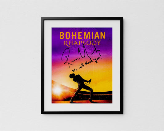 The image is a framed poster featuring a silhouette of a person playing the piano against a sunset background.