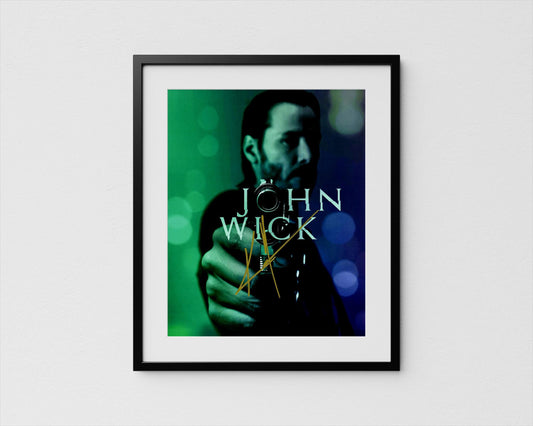 A framed poster featuring a close-up of a person&#39;s face, with the text &quot;JOHN WICK&quot; prominently displayed.
